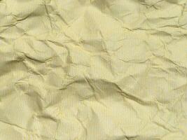 Yellow crumpled paper background with pattern for design photo