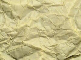 Yellow crumpled paper background with pattern for design photo