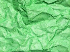 Pattern of green crumpled paper texture background. photo