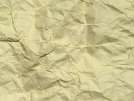 Yellow crumpled paper background with pattern for design photo