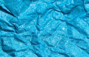 Texture of blue crumpled paper background for design photo