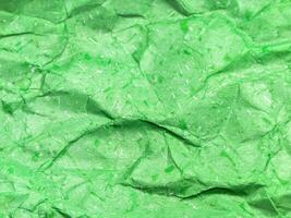 Pattern of green crumpled paper texture background. photo