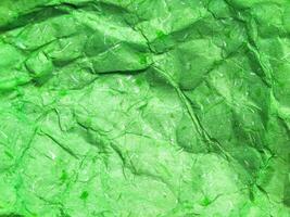 Pattern of green crumpled paper texture background. photo