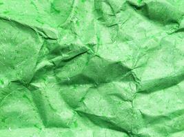 Pattern of green crumpled paper texture background. photo