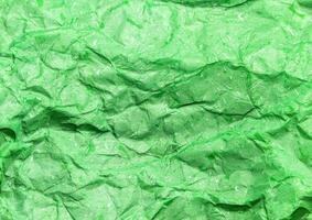 Pattern of green crumpled paper texture background. photo