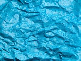 Texture of blue crumpled paper background for design photo