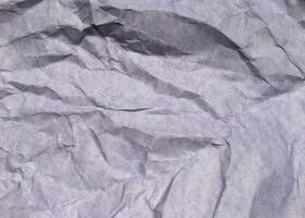 Abstract modern purple crumpled paper texture background. photo