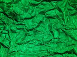 Closeup view of green crumpled paper texture background. photo