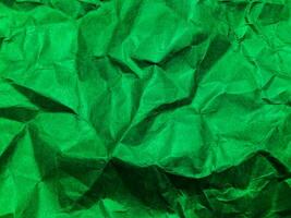 Closeup view of green crumpled paper texture background. photo