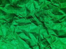 Closeup view of green crumpled paper texture background. photo