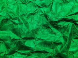 Closeup view of green crumpled paper texture background. photo