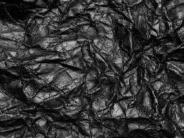 Black crumpled paper texture background. Copy space for design and artwork photo