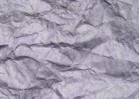 Abstract modern purple crumpled paper texture background. photo