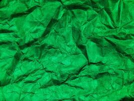 Closeup view of green crumpled paper texture background. photo