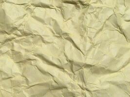 Yellow crumpled paper background with pattern for design photo