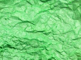 Pattern of green crumpled paper texture background. photo