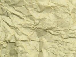 Yellow crumpled paper background with pattern for design photo