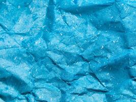 Texture of blue crumpled paper background for design photo