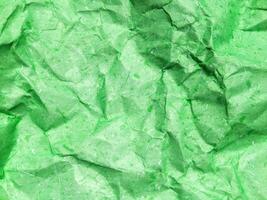 Pattern of green crumpled paper texture background. photo