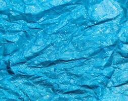 Texture of blue crumpled paper background for design photo