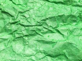 Pattern of green crumpled paper texture background. photo