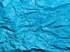 Texture of blue crumpled paper background for design photo