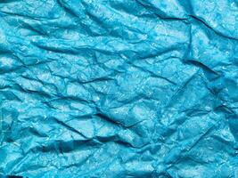 Texture of blue crumpled paper background for design photo