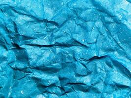Texture of blue crumpled paper background for design photo