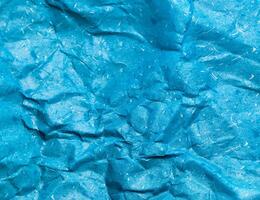 Texture of blue crumpled paper background for design photo