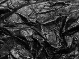 Black crumpled paper texture background. Copy space for design and artwork photo