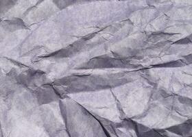 Abstract modern purple crumpled paper texture background. photo