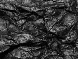 Black crumpled paper texture background. Copy space for design and artwork photo