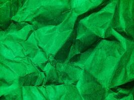 Closeup view of green crumpled paper texture background. photo