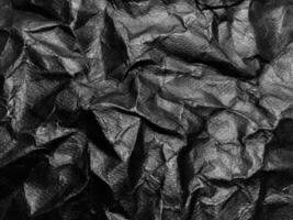 Black crumpled paper texture background. Copy space for design and artwork photo