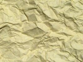 Yellow crumpled paper background with pattern for design photo