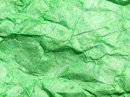 Pattern of green crumpled paper texture background. photo