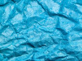 Texture of blue crumpled paper background for design photo