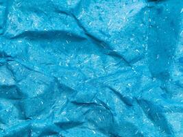 Texture of blue crumpled paper background for design photo