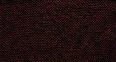 Texture of smooth knitted red brown sweater with pattern. Top view, close-up. Handmade knitting wool or cotton fabric texture. Background of knitting patterns front and back stitch. photo