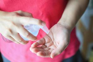 Woman using alcohol sanitizer gel rub for cleaning hand COVID-19 corona virus prevention concept photo