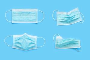 Surgical face mask on blue background protection against COVID-19 coronavirus. Healthcare and medical concept photo