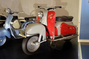 Batu, East Java, Indonesia - August  10, 2022, Antique red and blue vespa motorcycle in Angkut museum photo