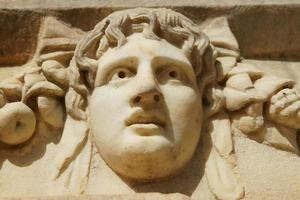 Ancient Mask Relief in Aphrodisias Ancient City in Aydin, Turkiye photo