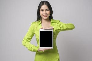 Beautiful woman using tablet over white background, technology concept. photo