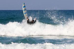 Surfing on high waves on the Mediterranean Sea in northern Israel. photo