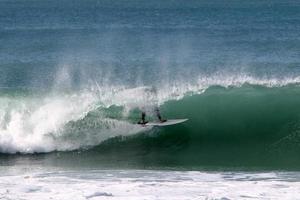 Surfing on high waves on the Mediterranean Sea in northern Israel. photo