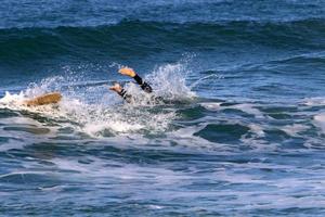 Surfing on high waves on the Mediterranean Sea in northern Israel. photo