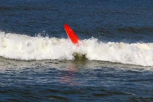 Surfing on high waves on the Mediterranean Sea in northern Israel. photo