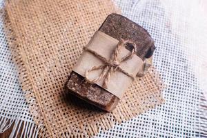 Piece of handmade soap with coffee beans. Spa concept for massage and relax. photo