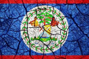 Dry soil pattern on the flag of Belize. Country with drought concept. Water problem. Dry cracked earth country. photo